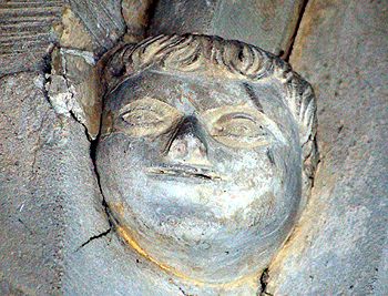 Head on the southern side of the north aisle west arch June 2012